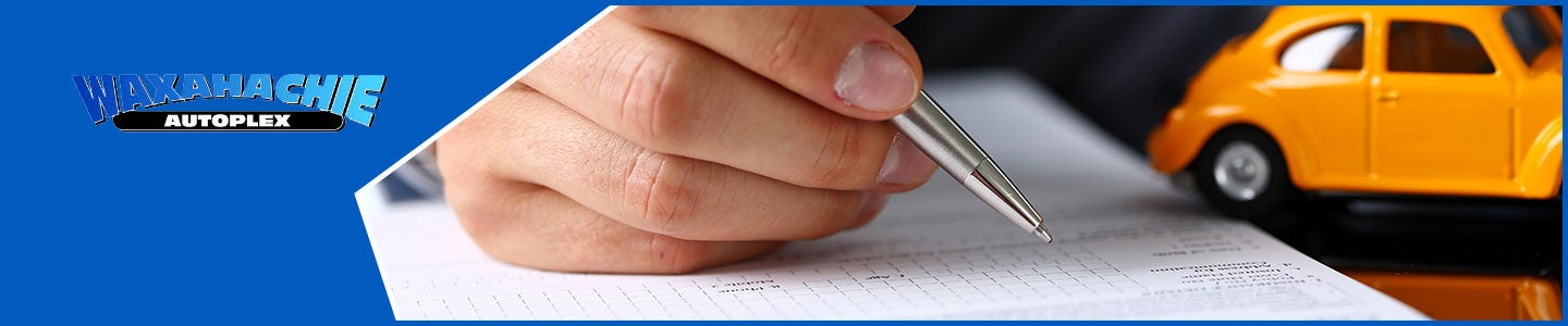 banner with Waxahachie Autoplex logo and someone writing something