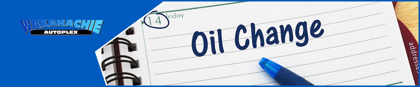 banner with Waxahachie Autoplex logo and oil change written on a planner with a pen