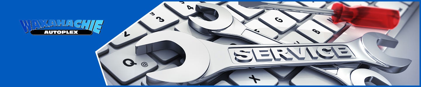 banner with Waxahachie Autoplex logo and a wrench on a keyboard