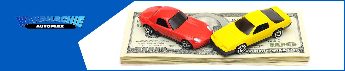 banner with Waxahachie Autoplex logo and 2 toy cars on a stack of $100 bills